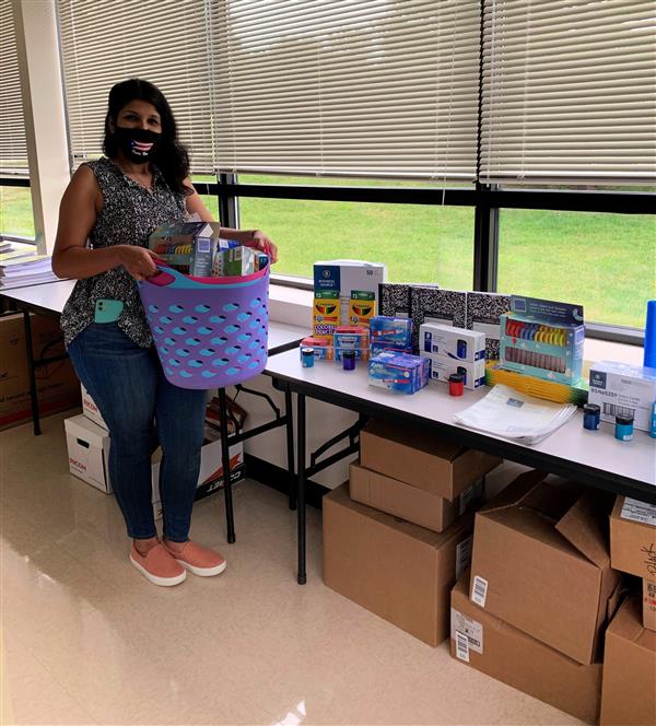 WCASD School caseworker, Veronica Ortiz, prepares donated school supplies for distribution to students. 